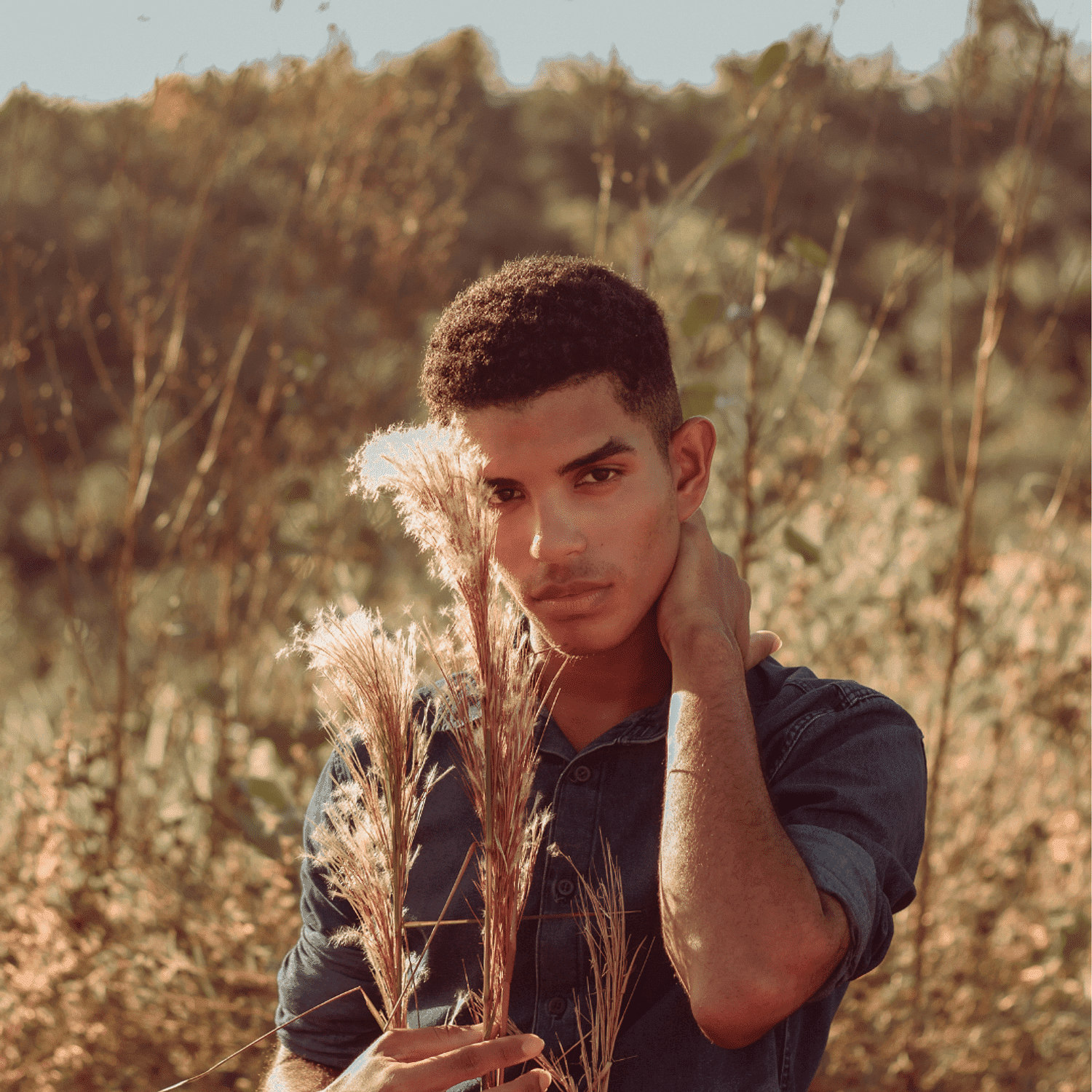 Portrait of Jonathan, a professional stylist at Ivy & Vine Beauty Haven, showcasing their expertise and style.